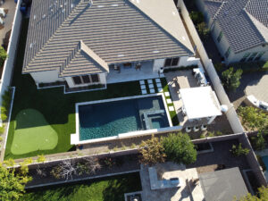 Thumbnail of http://Top-down%20aerial%20view%20of%20a%20Phoenix%20house%20roof%20and%20surrounding%20backyard,%20part%20of%20a%20pool%20design%20project.