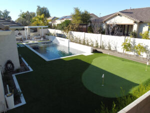 Thumbnail of http://Blurred%20wide%20view%20of%20a%20backyard%20featuring%20a%20modern%20pool%20with%20raised%20spa%20and%20paver%20deck%20next%20to%20a%20contemporary%20home%20in%20Phoenix,%20Arizona.