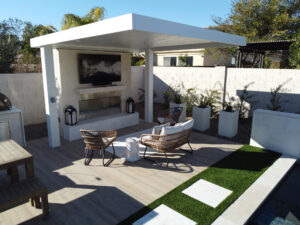 Thumbnail of http://Covered%20pergola%20structure%20with%20an%20outdoor%20TV%20and%20fireplace%20in%20a%20contemporary%20Phoenix%20backyard%20adjacent%20to%20a%20custom%20pool%20area%20by%20Arizona%20pool%20builders.