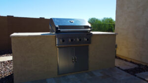 Thumbnail of http://Custom%20built-in%20outdoor%20barbecue%20island%20with%20stainless%20steel%20grill%20and%20travertine%20patio%20in%20Phoenix%20Arizona%20backyard%20by%20Caribbean%20Pools