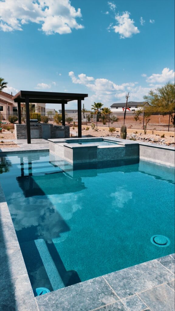 Blue swimming pool with raised spa and pergola in Queen Creek Arizona