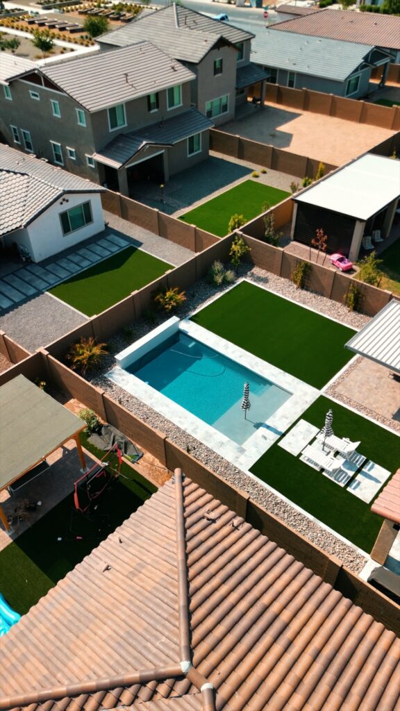 Aerial view of small backyard pool with artificial turf and travertine deck in Chandler Arizona built by Caribbean Pools