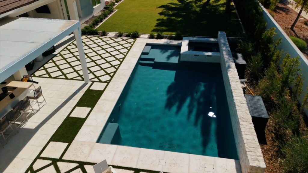 Inground pool with attached spa and stone deck in Phoenix Arizona