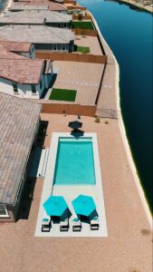 Thumbnail of http://Aerial%20photo%20of%20rectangular%20lap%20pool%20with%20teal%20umbrellas%20beside%20lakeside%20canal%20in%20Phoenix%20Arizona%20built%20by%20Caribbean%20Pools