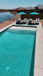 Thumbnail of http://Contemporary%20lap%20pool%20with%20lakeside%20view%20and%20turquoise%20loungers%20in%20Mesa%20Arizona%20built%20by%20Caribbean%20Pools