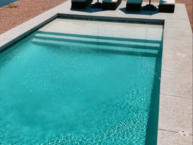 Contemporary lap pool with lakeside view and turquoise loungers in Mesa Arizona built by Caribbean Pools